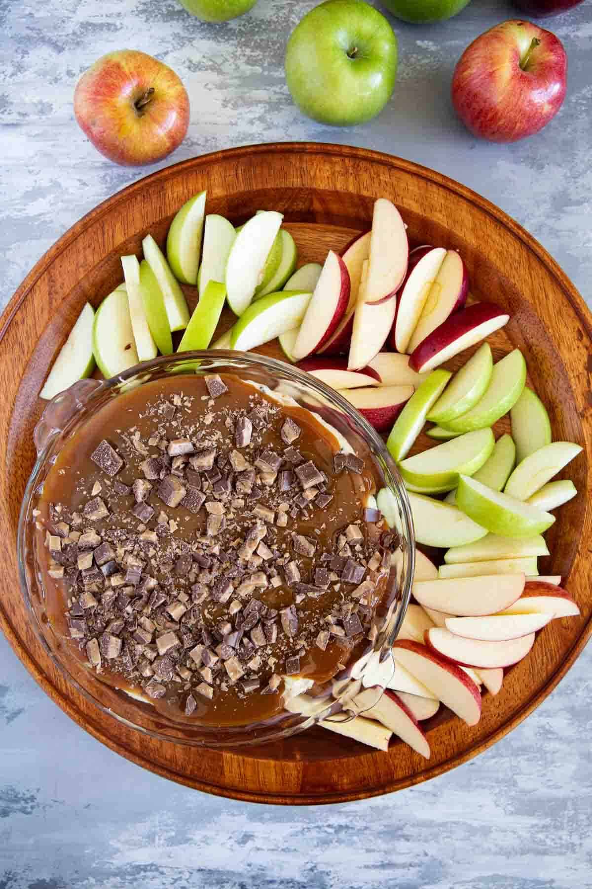 Caramel Apple Dip with red and green sliced apples for dipping.