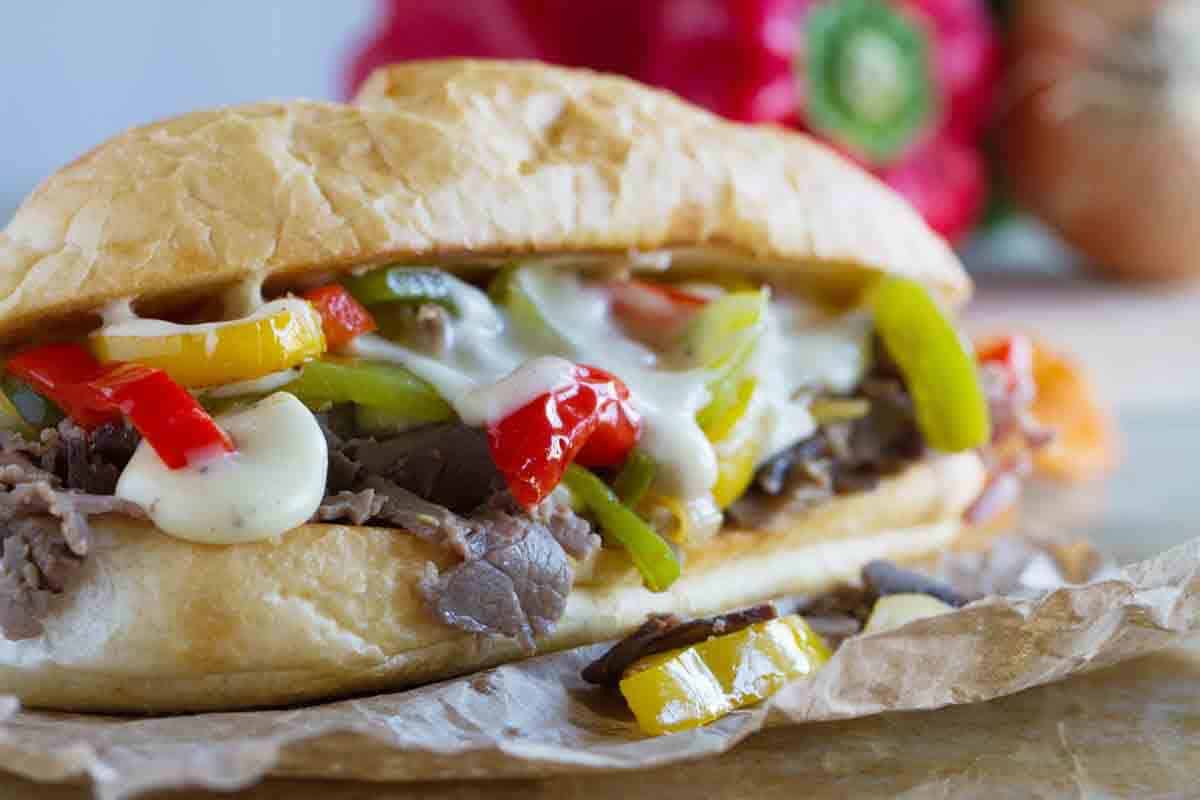 Cheesesteak recipe using deli roast beef and a homemade cheese sauce.