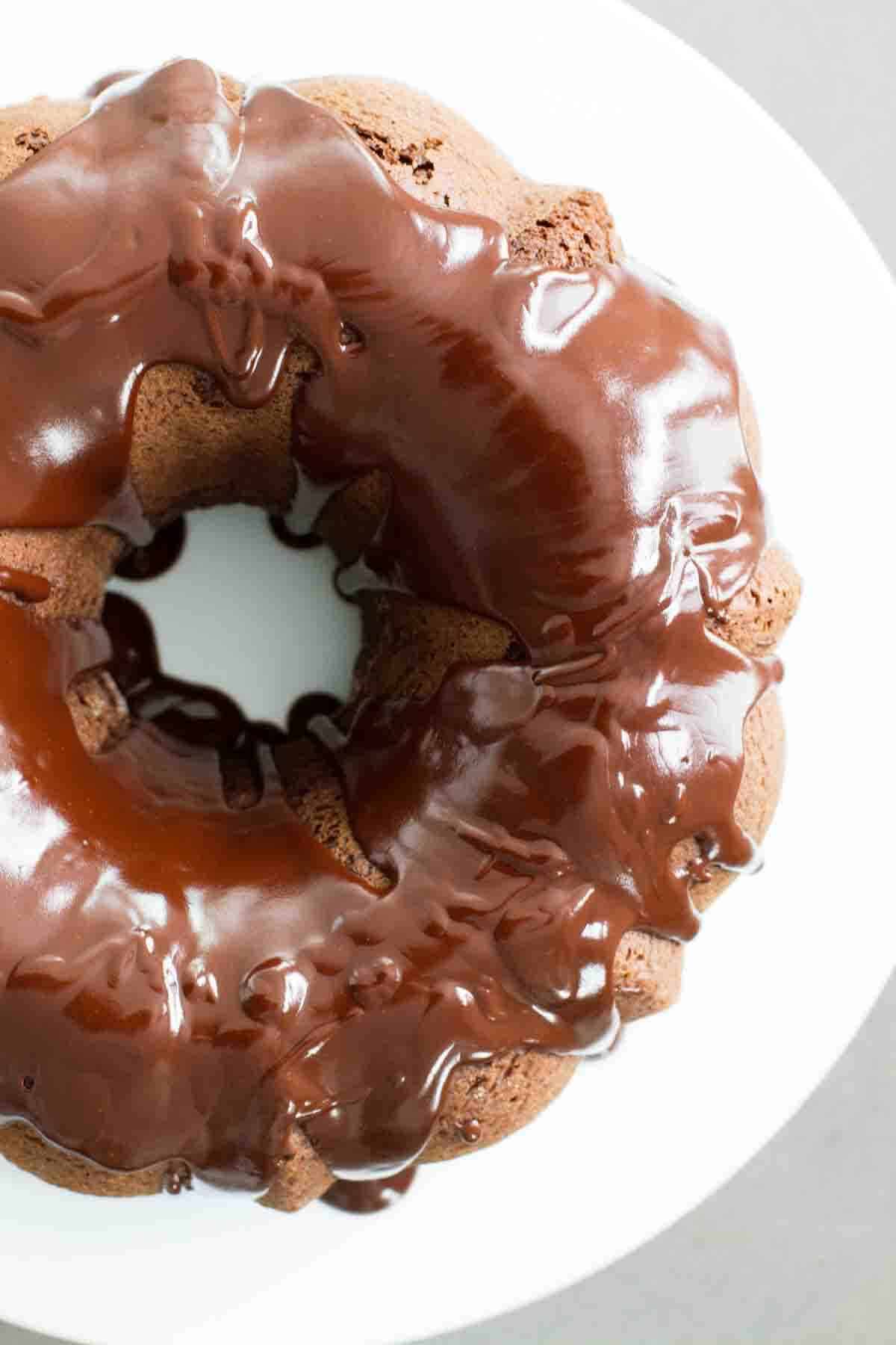 View of shiny chocolate icing over a chocolate bundt cake.
