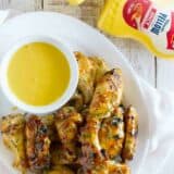 Maple Mustard Grilled Chicken Wings with mustard sauce for dipping.