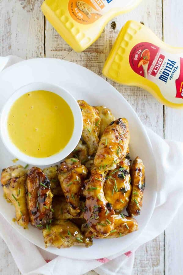 Maple Mustard Grilled Chicken Wings with mustard sauce for dipping.