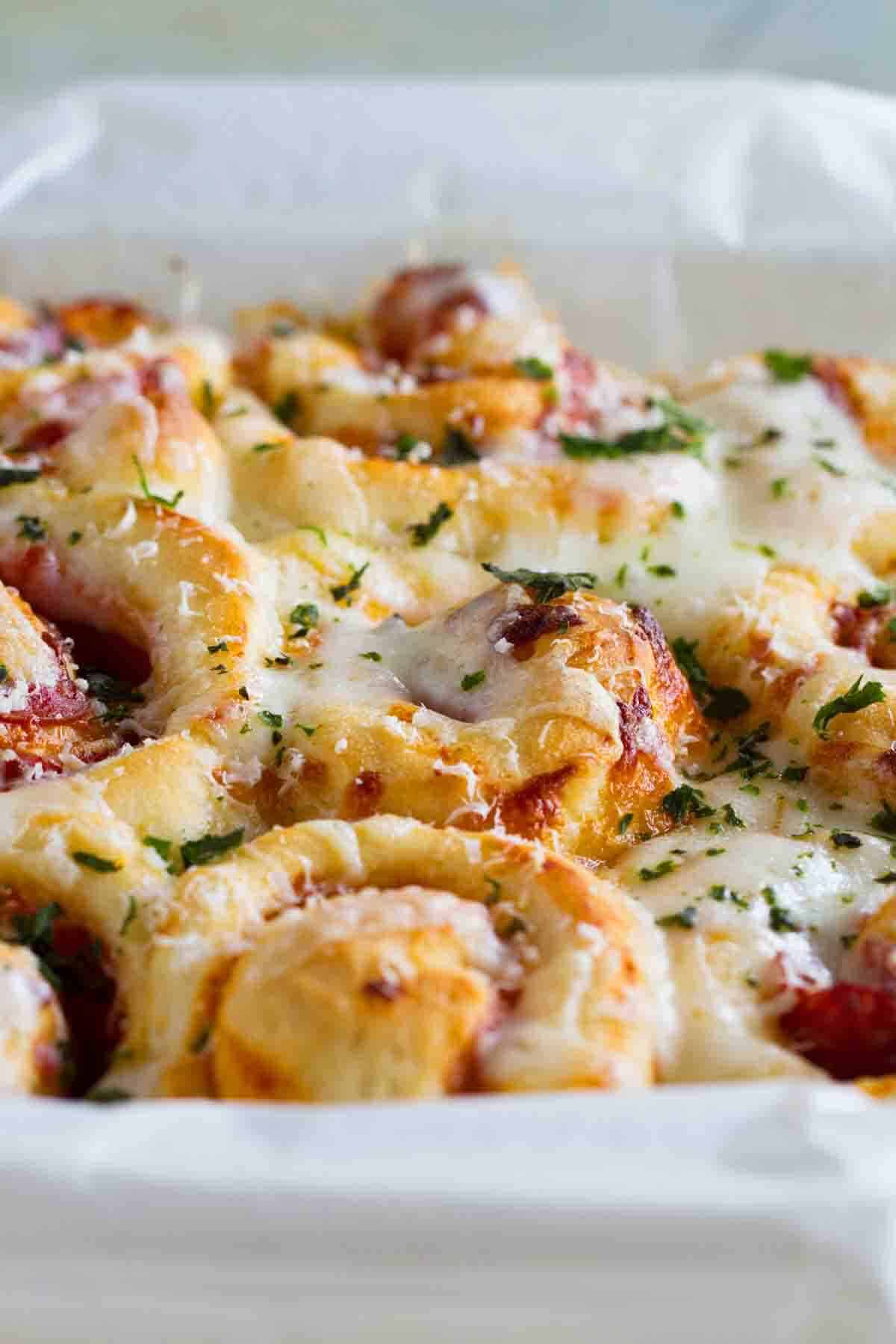 Homemade pizza rolls in a baking dish.