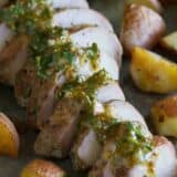 Sliced roasted pork tenderloin topped with mustard sauce and served with potatoes.