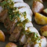 Sliced roasted pork tenderloin topped with mustard sauce and served with potatoes.