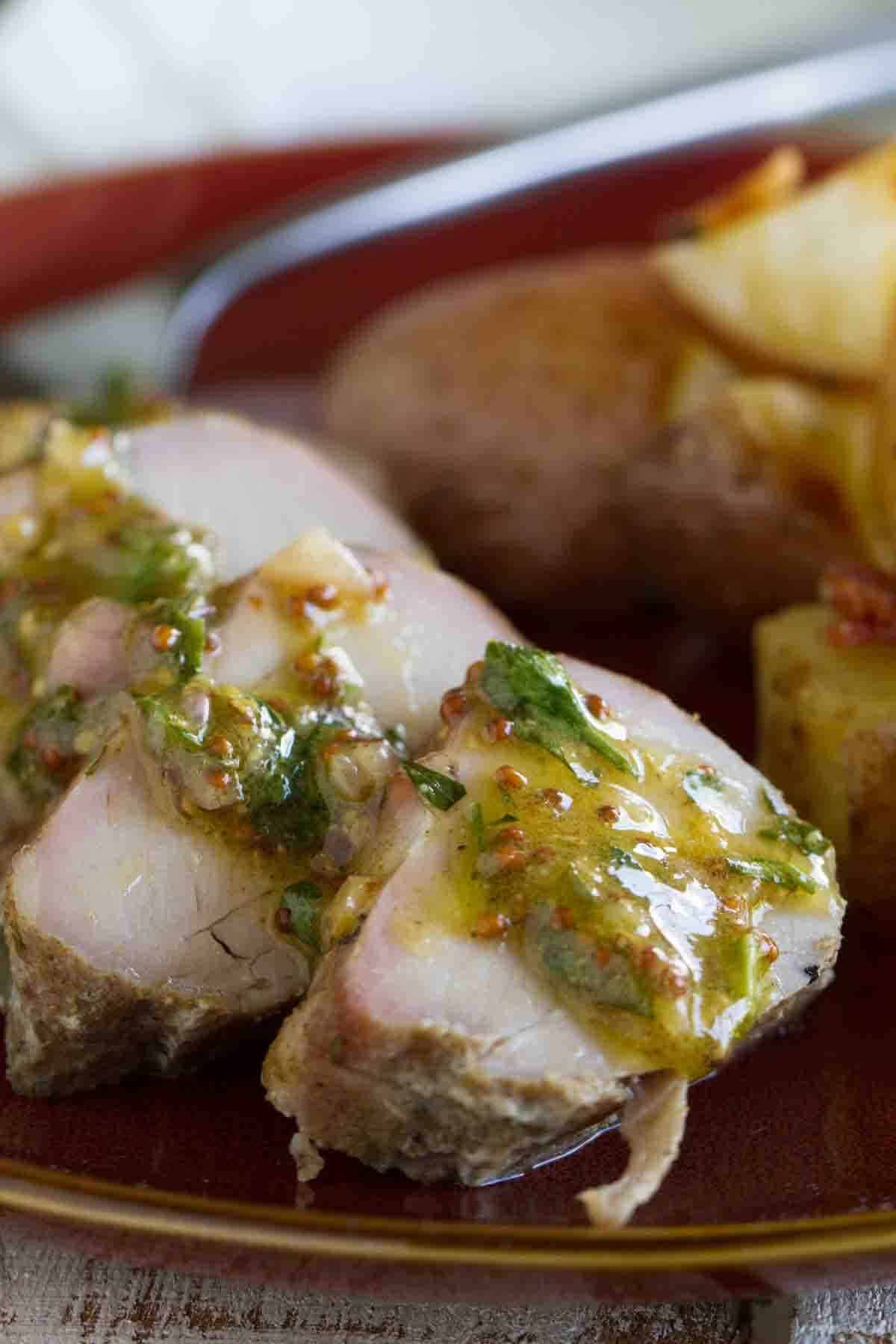 Slices of roast pork tenderloin topped with a mustard sauce.