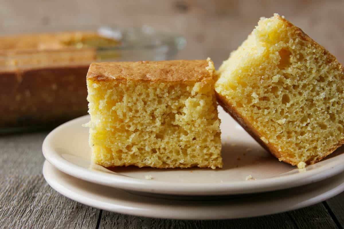 Two sliced of boston market cornbread on a plate.