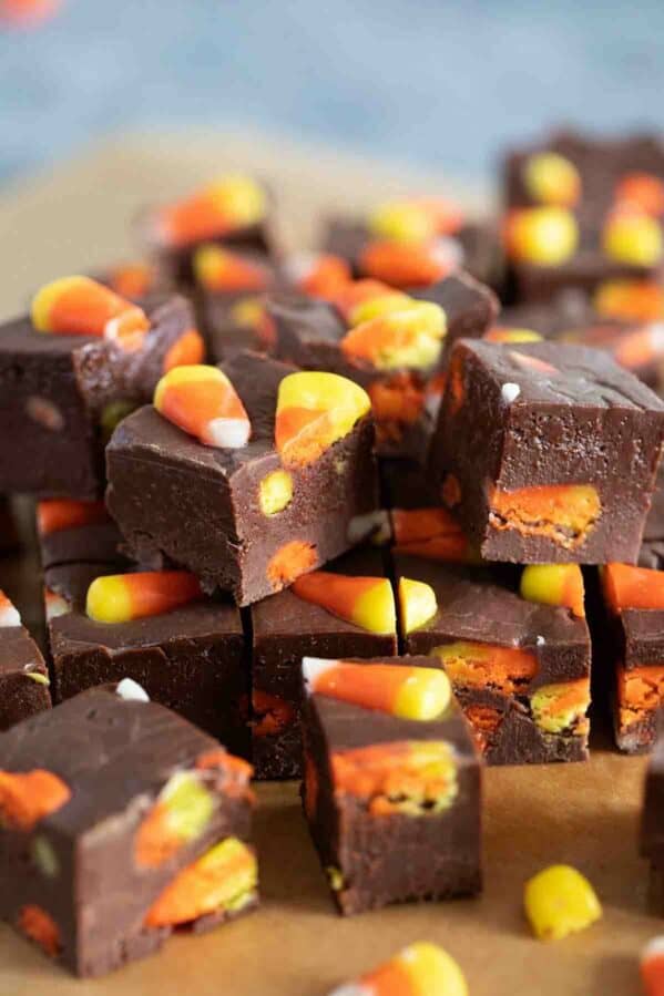 Pieces of candy corn fudge stacked on top of each other.