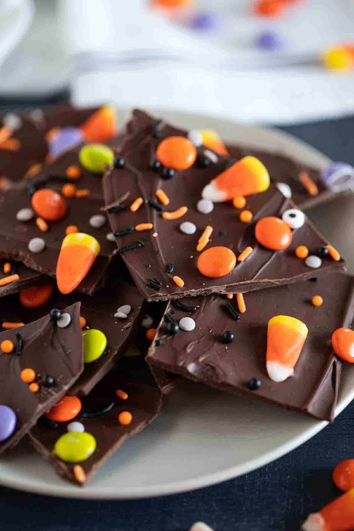 Plate full of Halloween Candy Bark topped with Halloween candy.