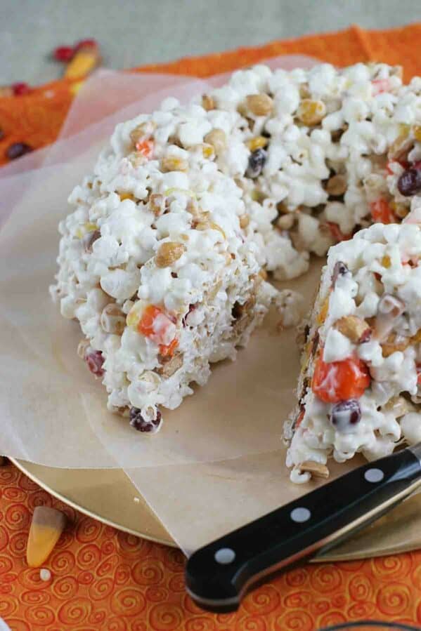 Halloween Popcorn Cake with a slice taken from it.