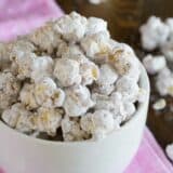 White bowl filled with muddy buddy popcorn.