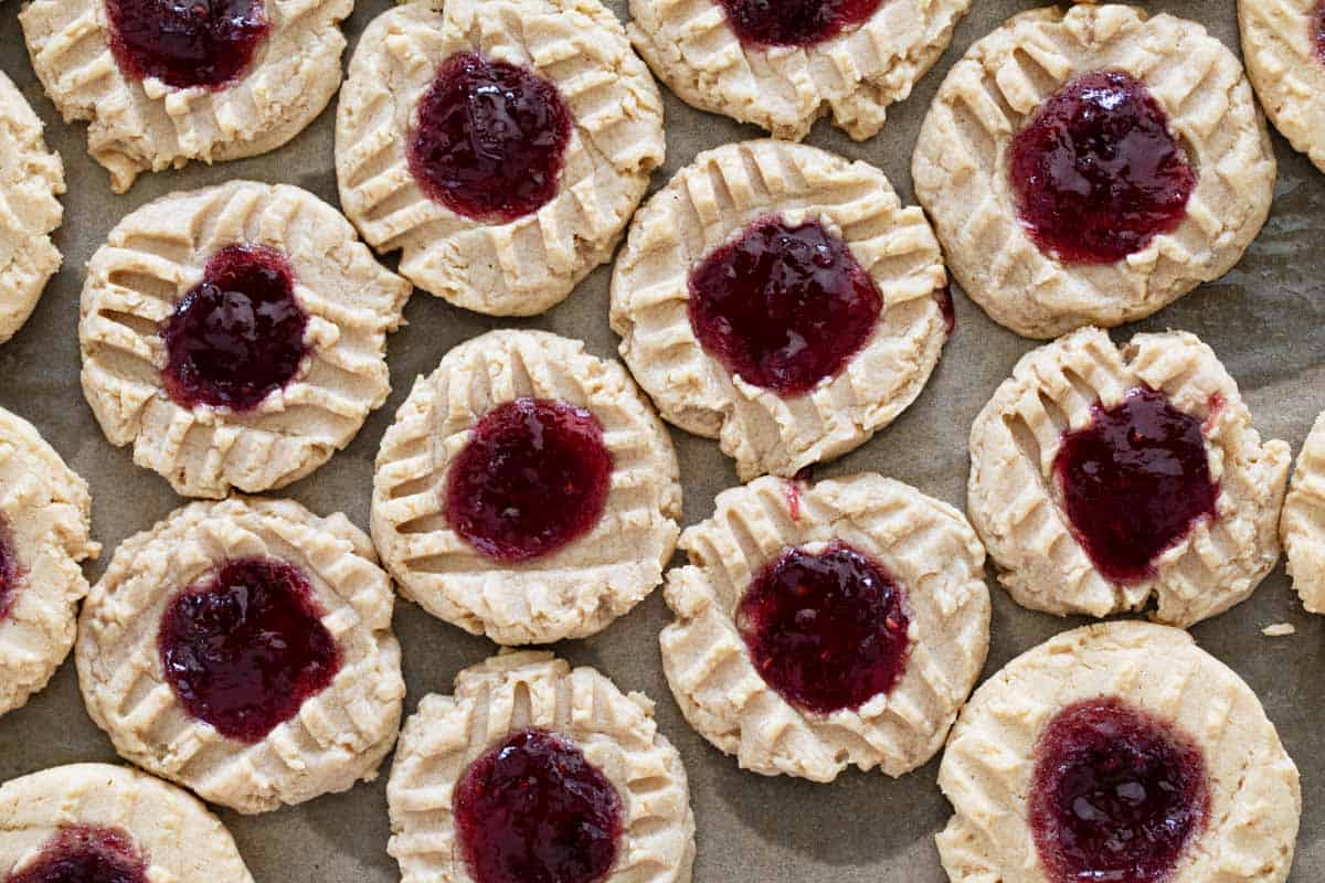 Peanut butter cookies topped with jelly and baked.