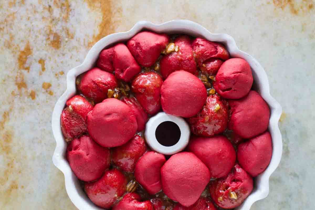 Fully risen red velvet pull apart bread in a bundt pan.