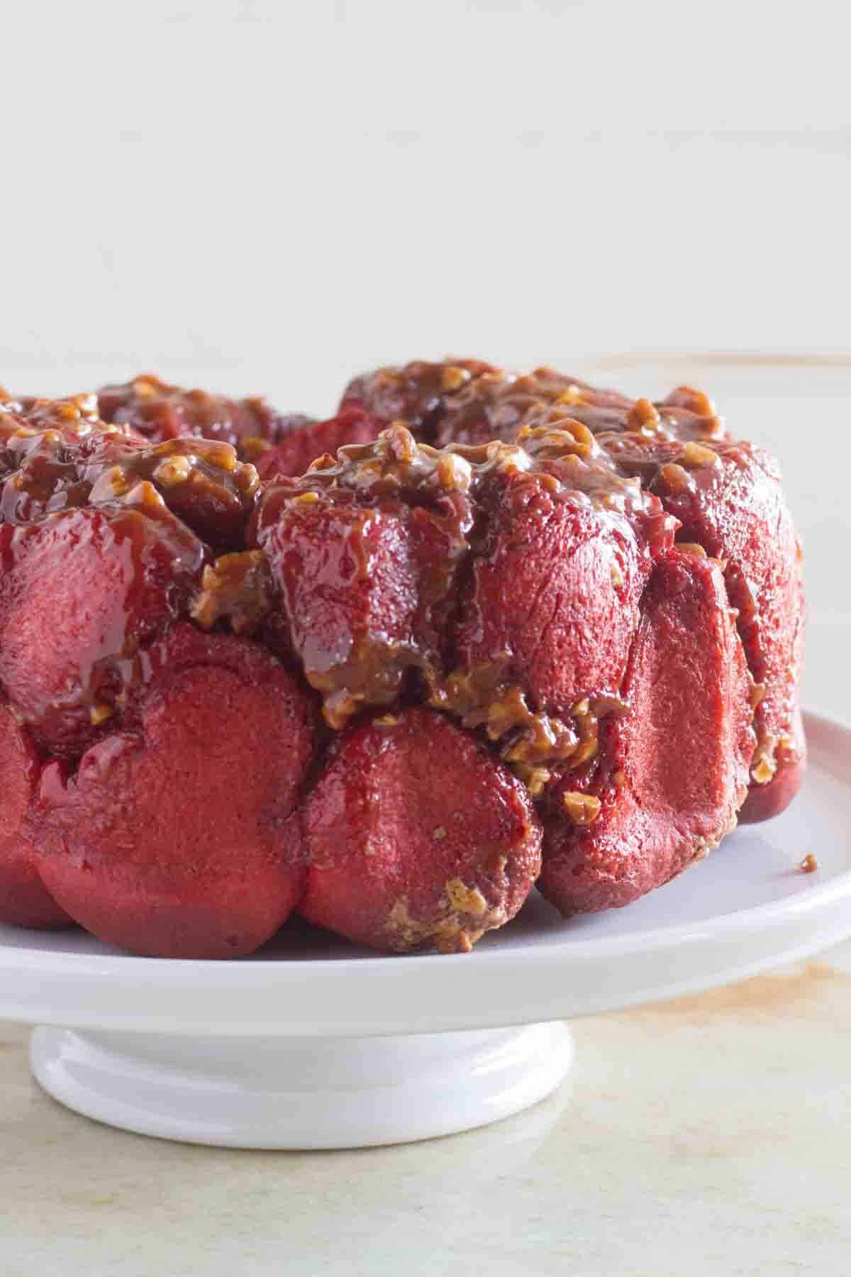 Full loaf of Red Velvet Pull Apart Bread on a cake stand.