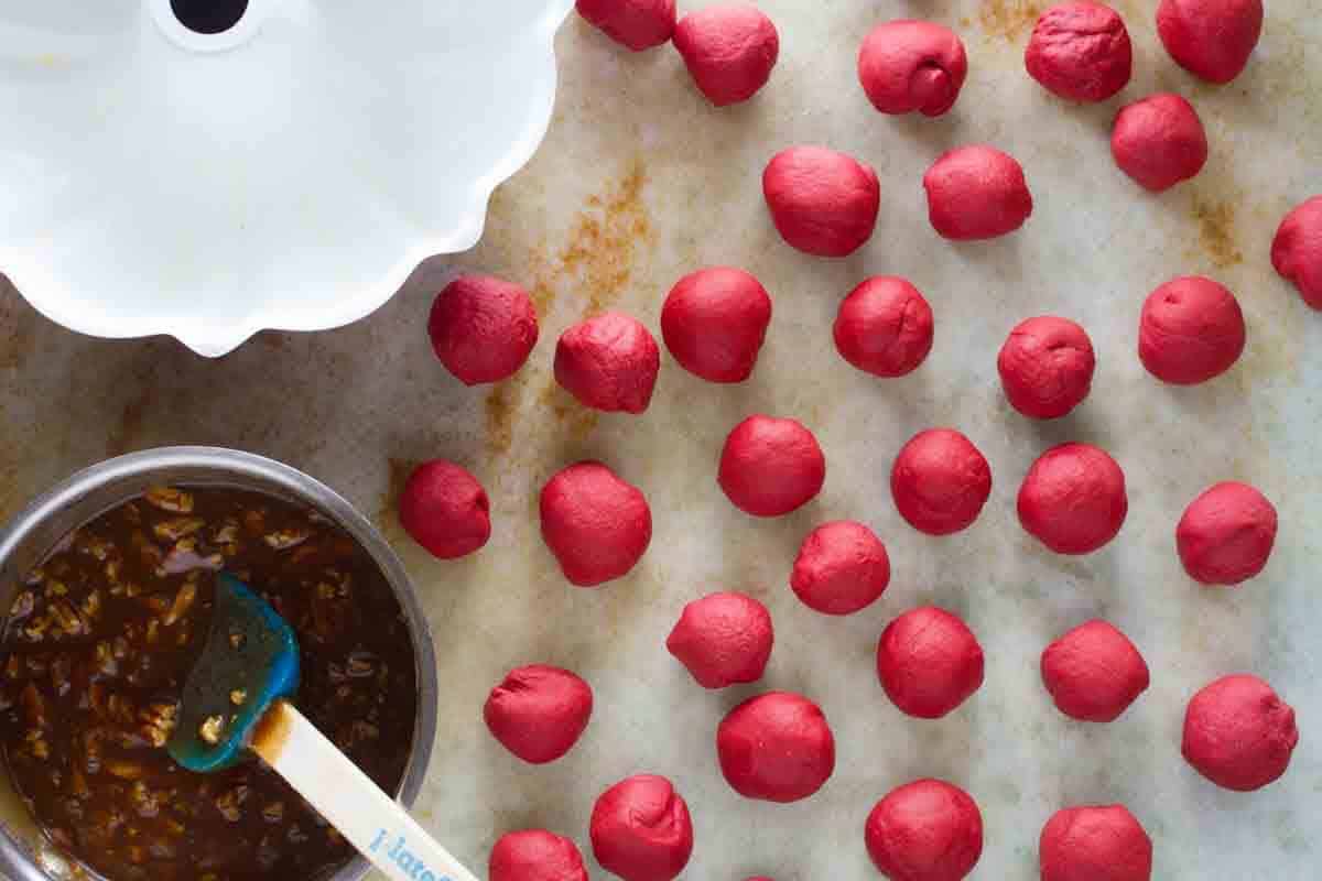 Making balls of dough to make red velvet pull apart bread.