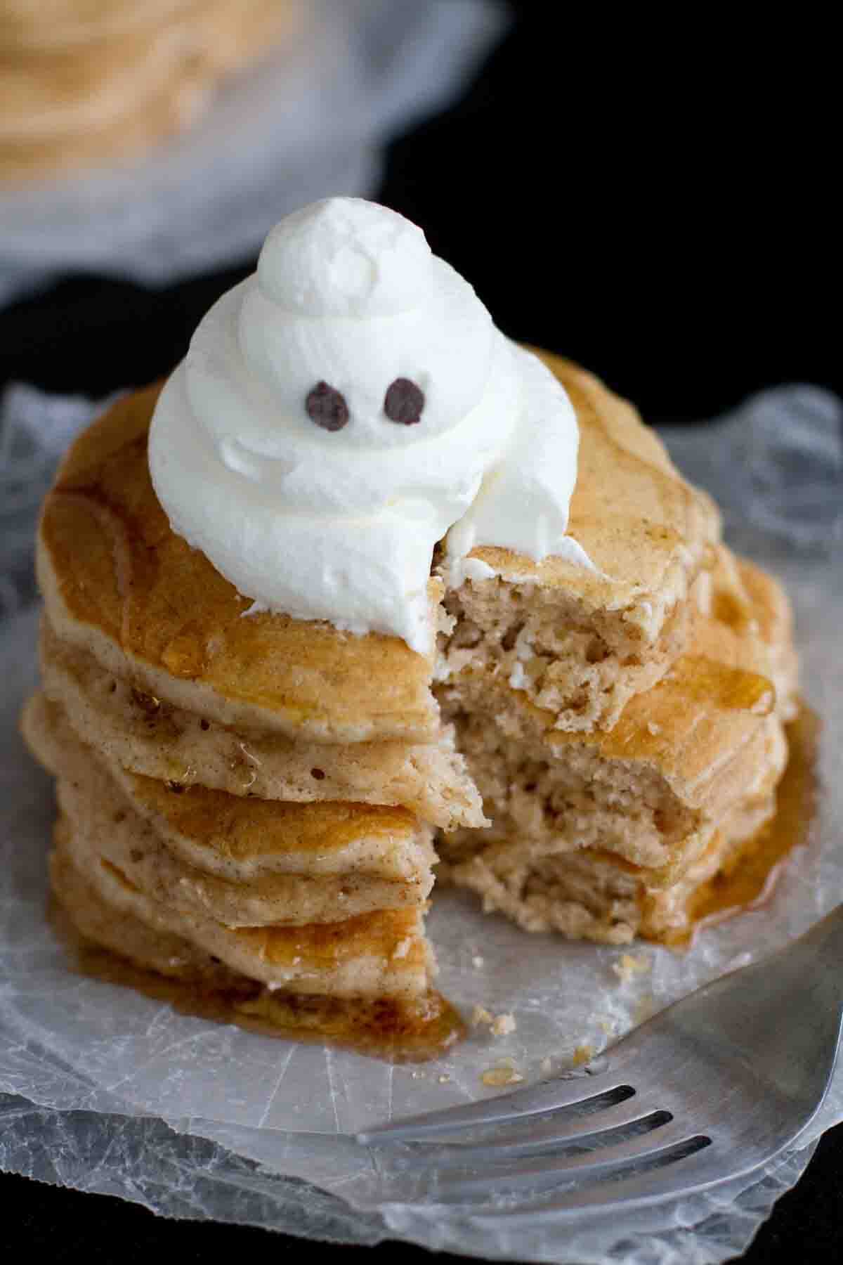 Stack of spiced ghost pancakes with a bite taken from them.