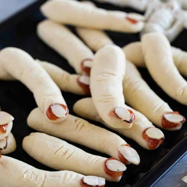 Witch Fingers cookies on a black tray.