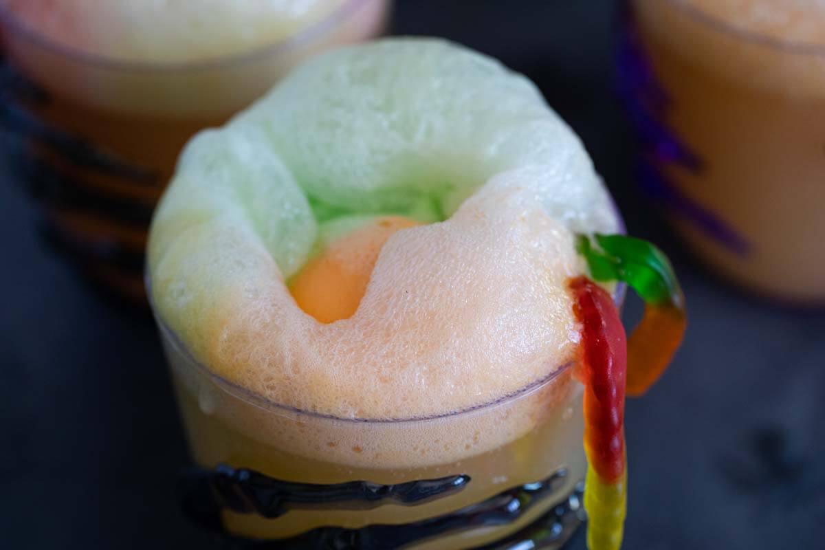 Halloween drink topped with sherbet and gummy worms.