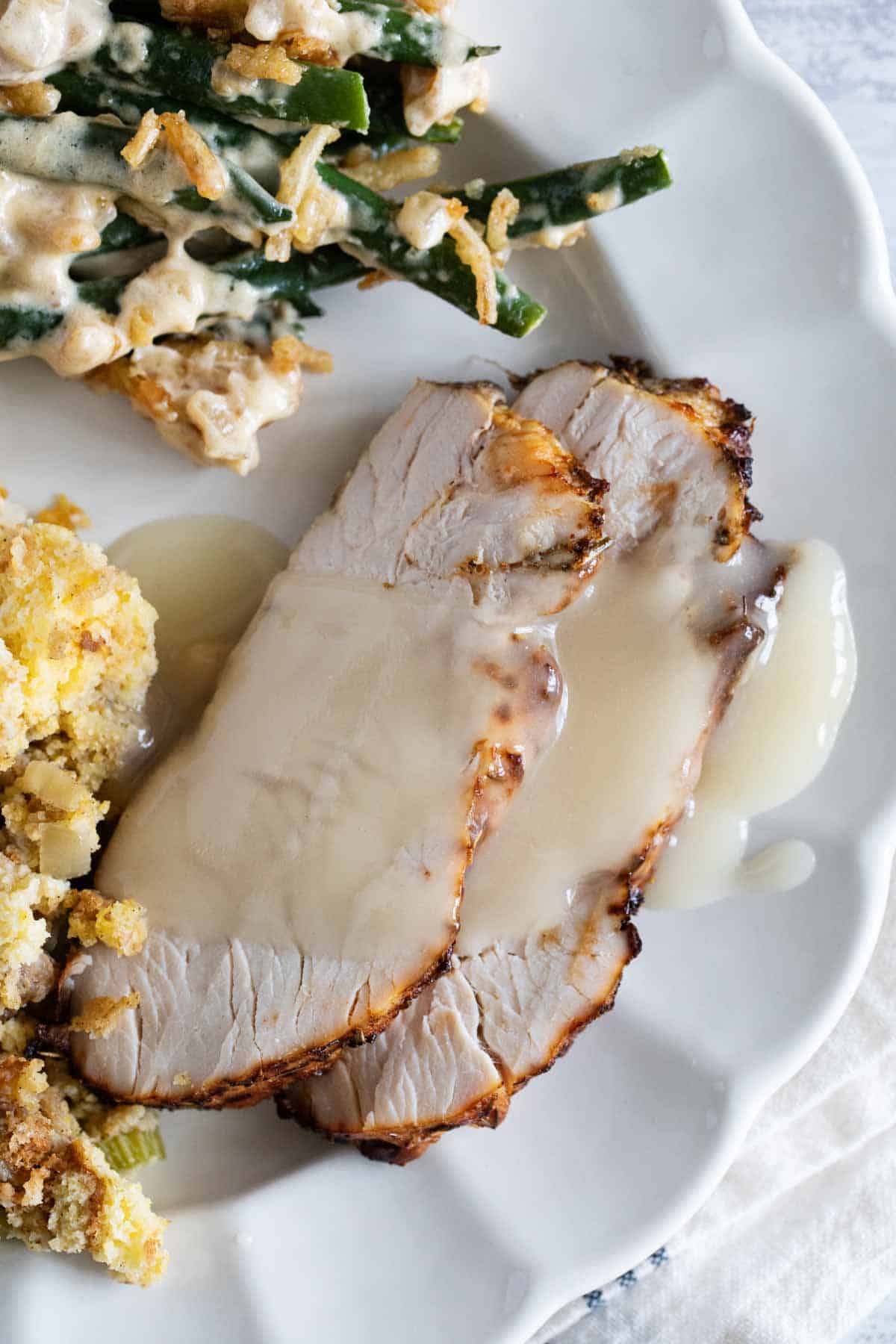 Two slices of Air Fryer Turkey Breast with gravy.