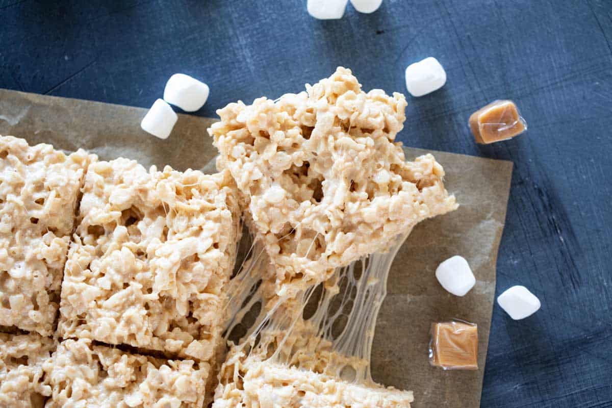 Caramel Rice Krispie Treats cut into squares and pulled apaprt.