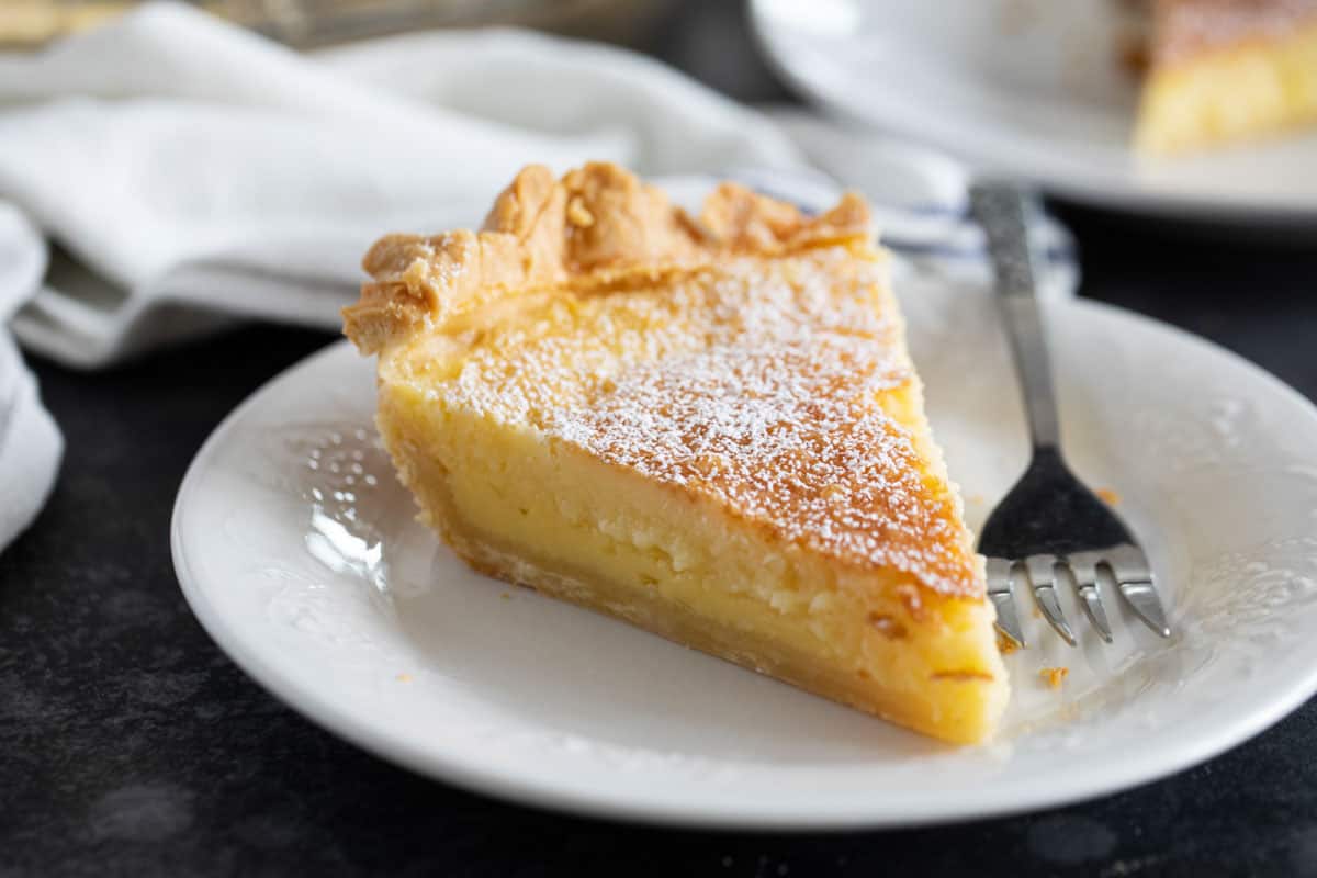 Slice of Chess Pie on a plate with a fork.