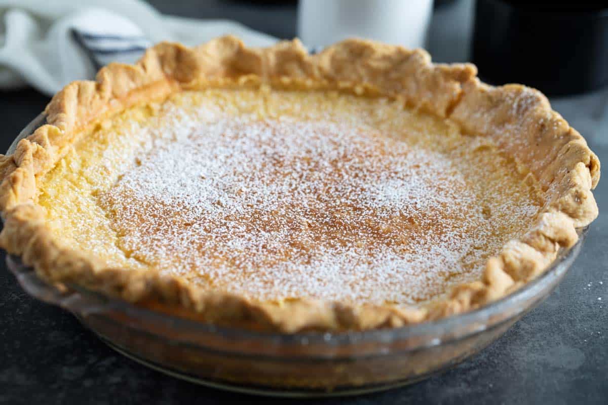 Full chess pie sprinkled with powdered sugar.