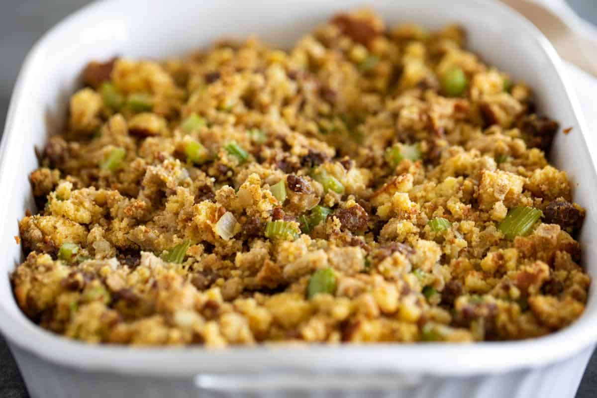 White casserole dish filled with cornbread stuffing.