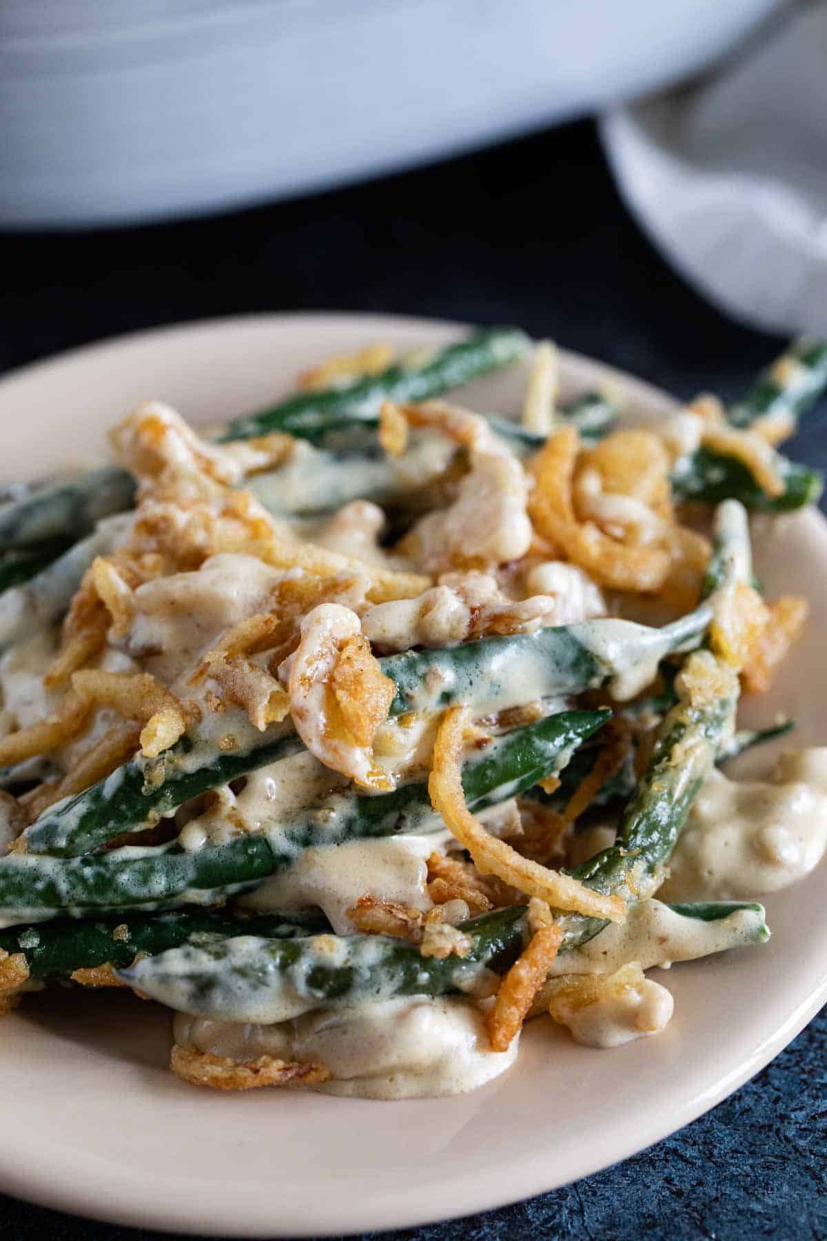 Plate with green bean casserole topped with crispy onions.