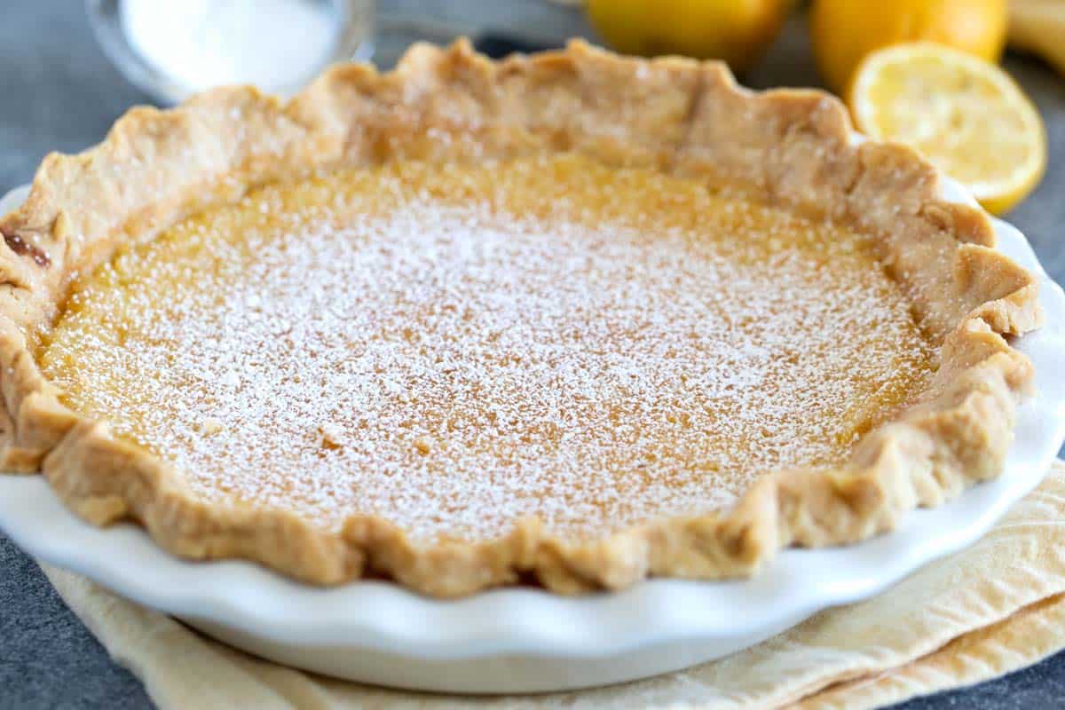 Full Lemon Chess Pie that has been sprinkled with powdered sugar.