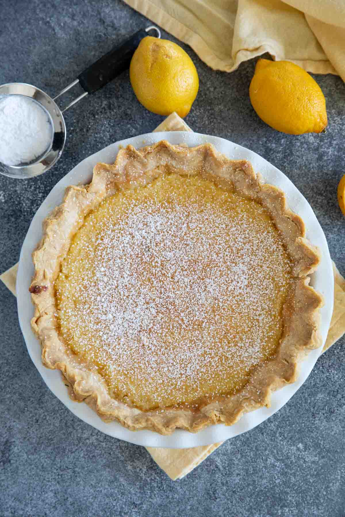 Full lemon chess pie sprinkled with powdered sugar.