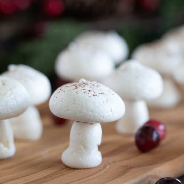 Meringue mushrooms topped with cocoa powder.