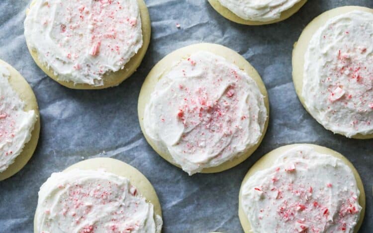 Peppermint holiday soft sugar cookies on parchment.