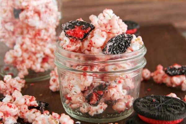 Jar filled with peppermint popcorn with cookies.