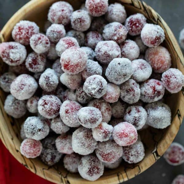 Bowl of sugared cranberries stacked.