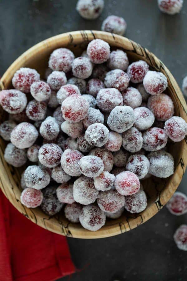 Bowl of sugared cranberries stacked.