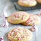 Candy Cane Kiss Stuffed Pudding Cookies with icing made from peppermint kisses.