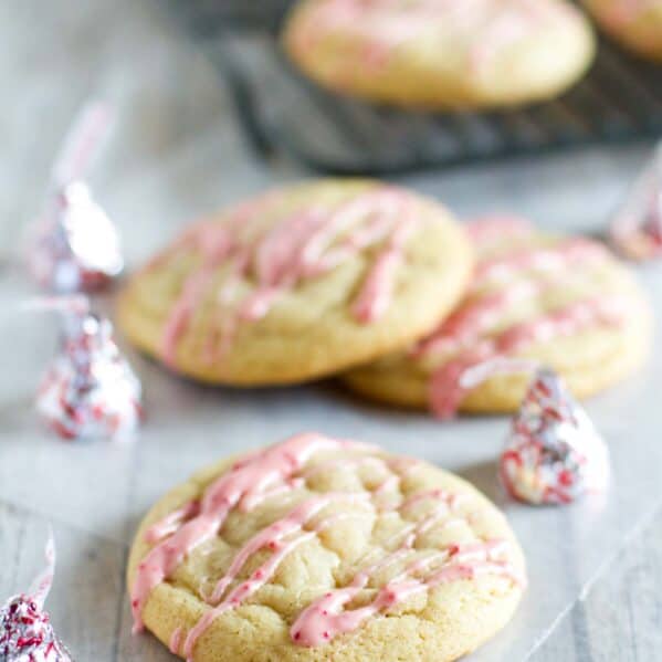 Candy Cane Kiss Stuffed Pudding Cookies with icing made from peppermint kisses.