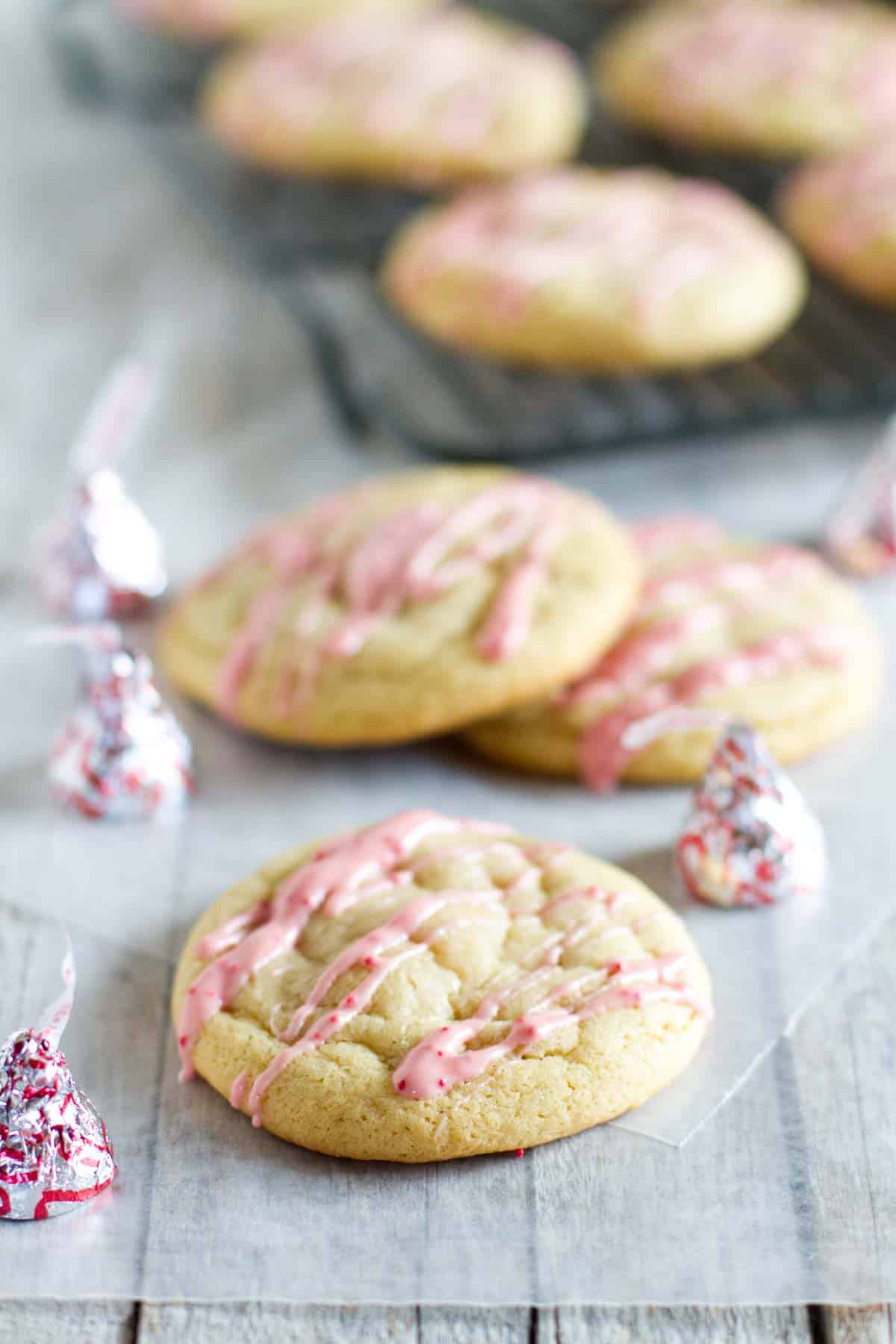 Candy Cane Kiss Stuffed Pudding Cookies with icing made from peppermint kisses.