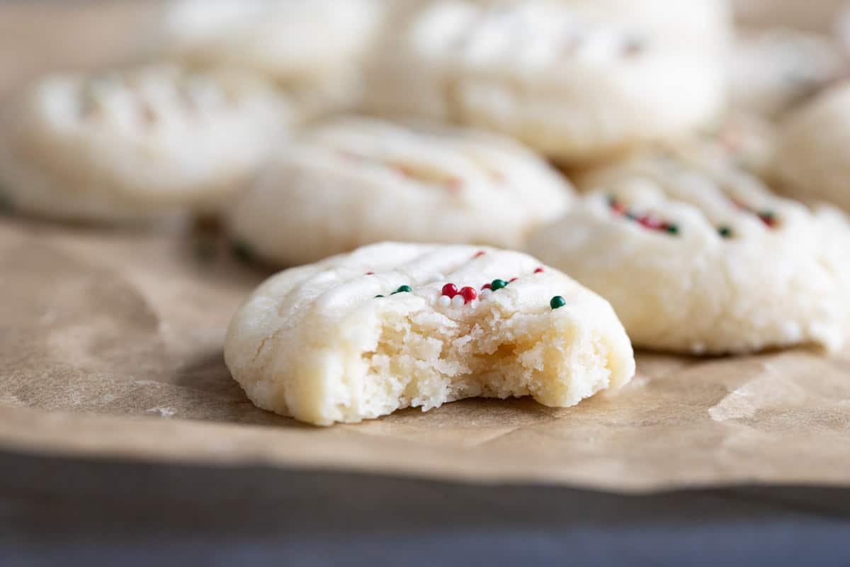 Christmas Shortbread Cookies with a bite taken from one.