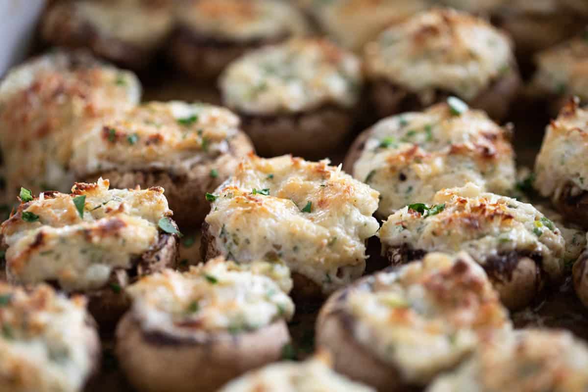 Crab stuffed mushrooms in a baking dish.