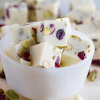 Slices of Creamy Cranberry Pistachio Fudge in a small bowl.