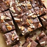 Easy fudge recipe cut into squares and topped with pecans.