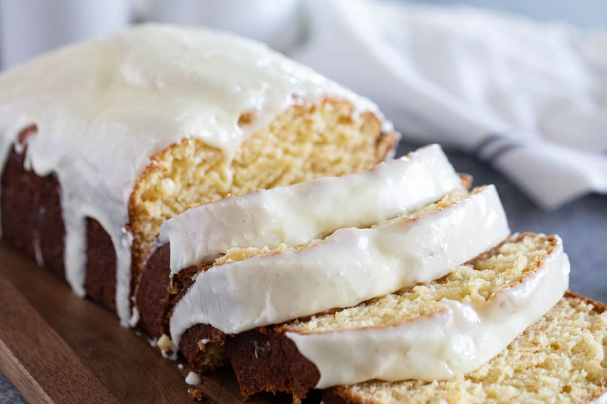 Sliced loaf of Eggnog Bread with Eggnog Glaze.