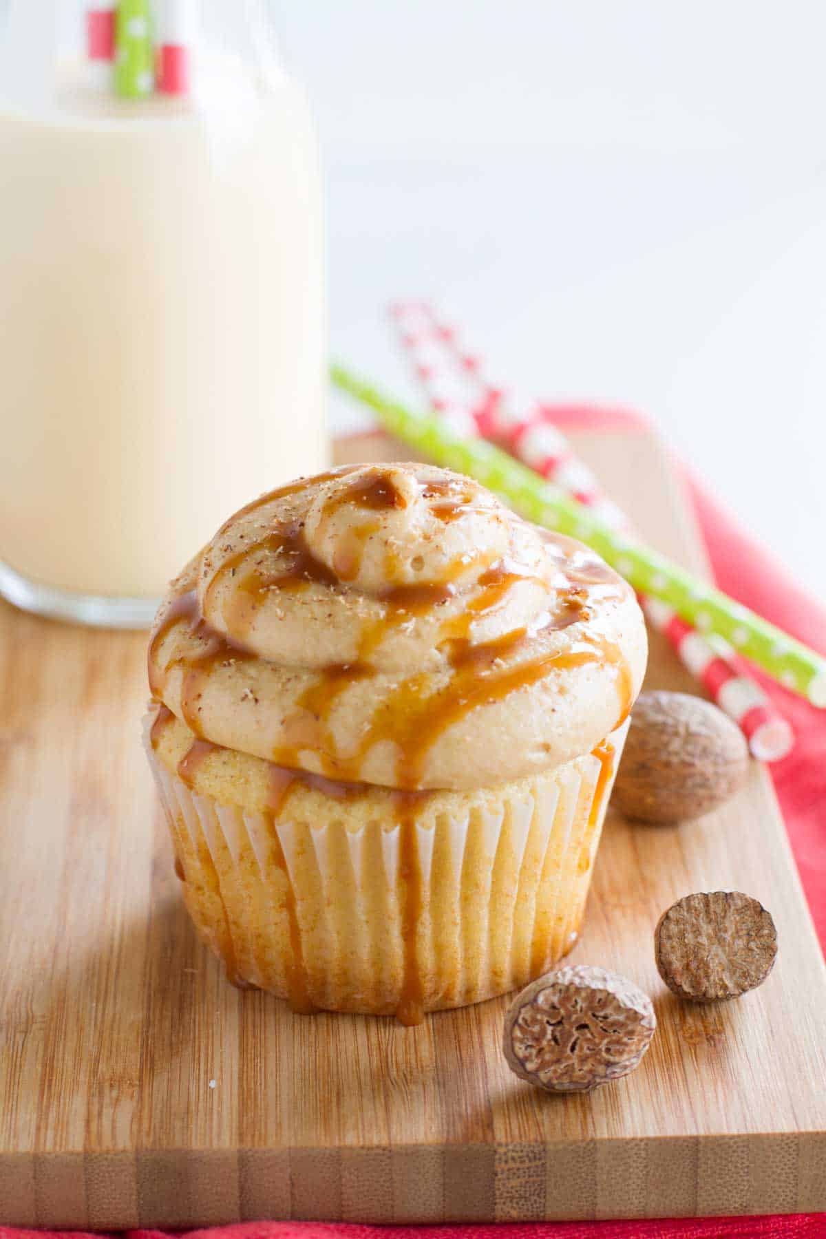 Eggnog Cupcake on a cutting board with fresh nutmeg on the side.