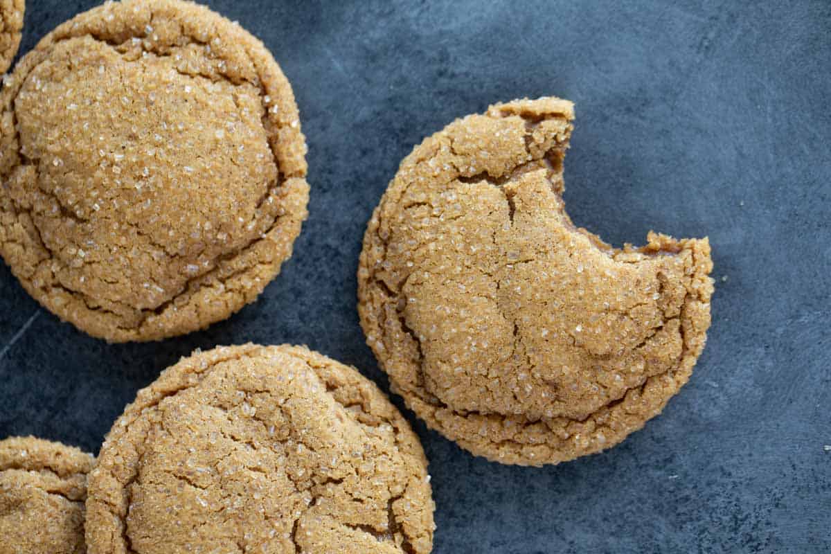 Soft ginger cookies with a bite taken from one cookie.