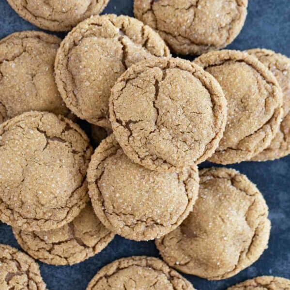 Pile of soft ginger cookies on a blue background.