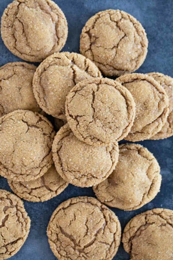 Pile of soft ginger cookies on a blue background.