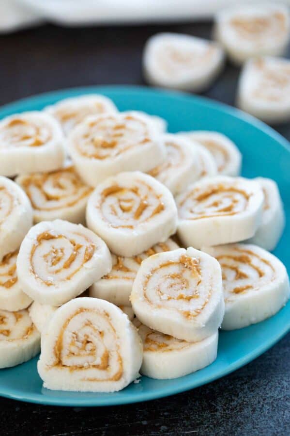 Old fashioned potato candy with peanut butter on a blue plate.