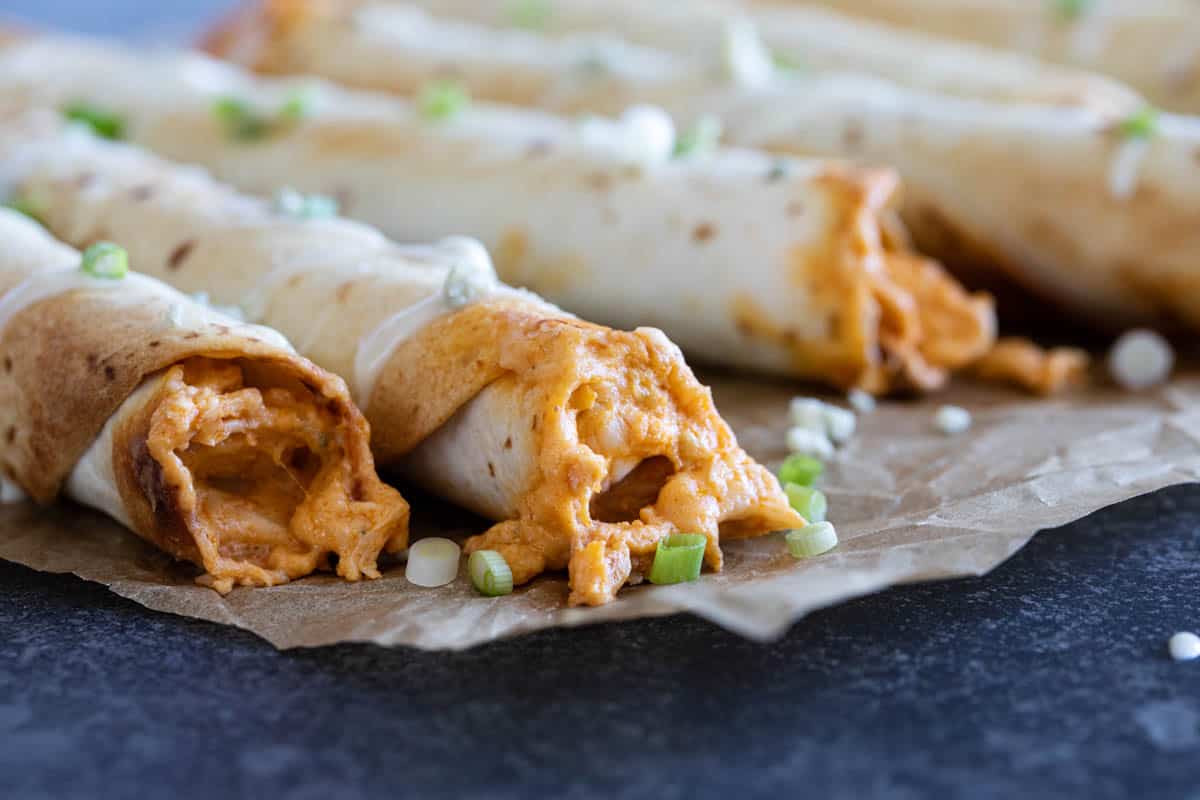 Buffalo chicken taquitos that are baked in flour tortillas.
