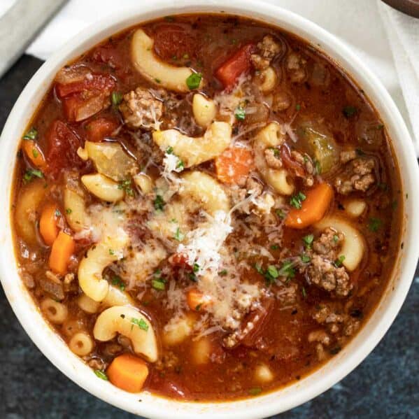 Bowl of hamburger soup topped with parmesan cheese.