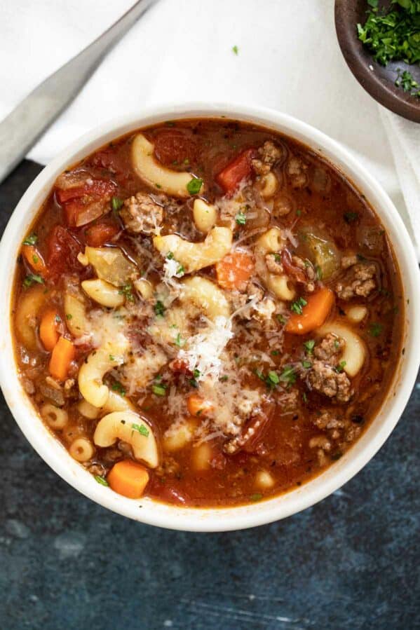 Bowl of hamburger soup topped with parmesan cheese.